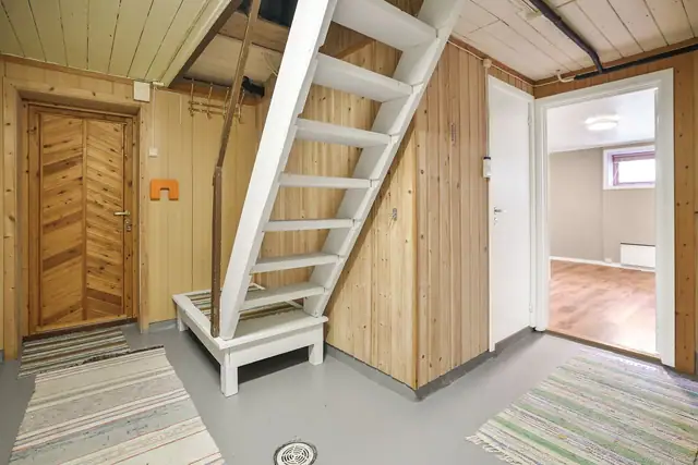 Kjeller består av to soverom, bad, kjøkken og flere boder, og er ikke godkjent for varig opphold.